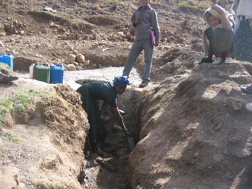 Local woman using water source that is being developed at Metkoria
